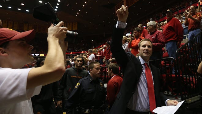 Fred Hoiberg acknowledges fans as he leaves Hilton Coliseum after Iowa State's win over Michigan on Nov. 17, 2013, at Hilton Coliseum in Ames.