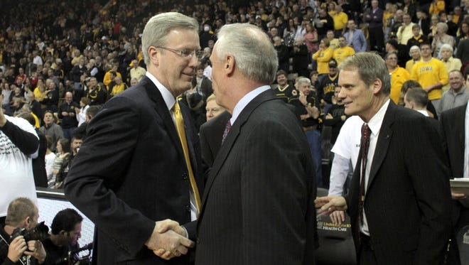 Iowa head coach Fran McCaffery chats with Wisconsin head coach Bo Ryan prior to their game at Carver-Hawkeye Arena on Saturday, Jan. 19, 2012.