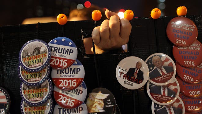 Kathy Young of Kansas City, Mo. displays Donald Trump pins prior to his arrival at the University of Iowa Field House in Iowa City on Tuesday, Jan. 26, 2016.