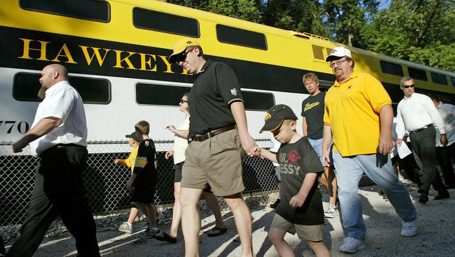 Passengers leave the Hawkeye Express after riding from Coralville to Kinnick Stadium in 2008.