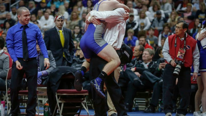 Dike New Hartford senior Trent Johnson celebrates a state win over Sibley-Ocheyedan senior Dylan Schuck in their match at 145 pounds during the Iowa Class 1A wrestling finals on Saturday, Feb. 18, 2017, at Wells Fargo Arena in Des Moines.