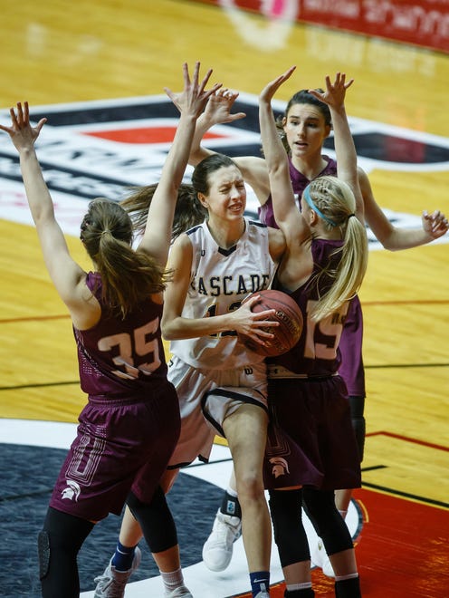 Cascade's Jordan Simon (12) tries to get a shot off between Grundy Center's Kylie Willis (35) and Grundy Center's Maddie McMartin (15) during the first half of their 2A girls state basketball championship game at Wells Fargo Arena on Saturday, March 3, 2018, in Des Moines. Cascade takes a 22-15 lead into halftime.