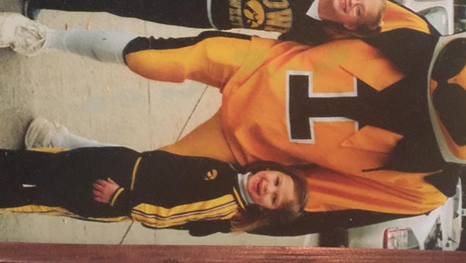 Matthew Meyer (left), Makenzie Meyer (middle) and Megan Meyer (right) pose with Herky the Hawk as children.