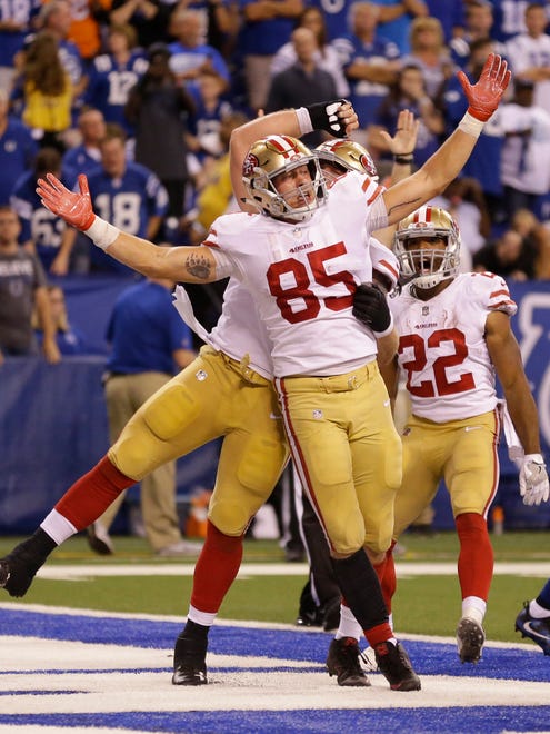 San Francisco 49ers' George Kittle (85) celebrates a five-yard touchdown reception during the second half of an NFL football game against the Indianapolis Colts, Sunday, Oct. 8, 2017, in Indianapolis. (AP Photo/Michael Conroy)
