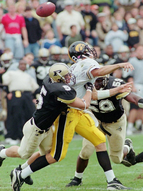 From 1998: Iowa quarterback Scott Mullen fumbles as he is hit by Purdue's Billy Gustin, left, at West Lafayette, Indiana. Purdue sacked Mullen three times in the first half, intercepted a pass and also recovered one of his fumbles in Iowa's loss.