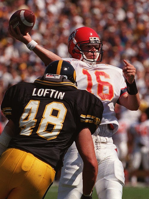 From 1998: Todd Bandhauer, right, gets off a pass despite pressure from Iowa's Ryan Loftin during the 1998 Cy-Hawk football game in Iowa City.