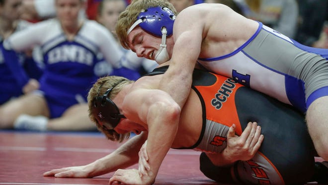 Dike New Hartford senior Trent Johnson controls Sibley-Ocheyedan senior Dylan Schuck in their match at 145 pounds during the Iowa Class 1A wrestling finals on Saturday, Feb. 18, 2017, at Wells Fargo Arena in Des Moines.