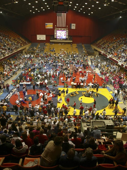 From 2002: Wrestlers crowd the mats during warmups before the first session of state wrestling at Veterans Memorial Auditorium.