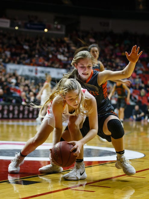 Grinnell's Megan Doty (23) and Marion's Kayba Laube (24) fight for a loose ball during the second half of their 4A girls state basketball championship game at Wells Fargo Arena on Friday, March 2, 2018, in Des Moines. Marion would go on to win 69-48.