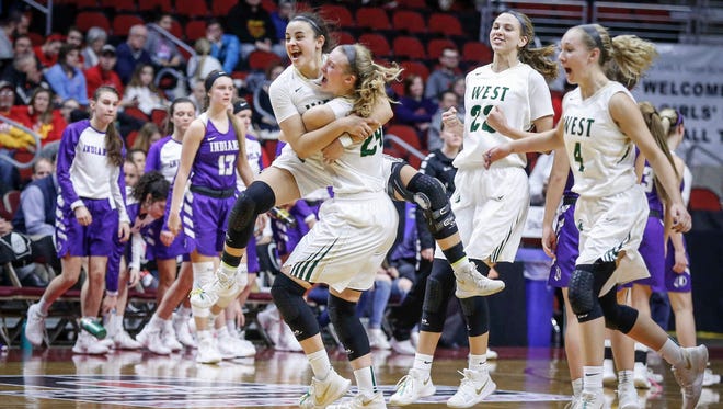 Members of the Iowa City West girls basketball team celebrate a win over Indianola during the 5A semifinal game at the girls state basketball tournament on Thursday, March 1, 2018, at Wells Fargo Arena in Des Moines.