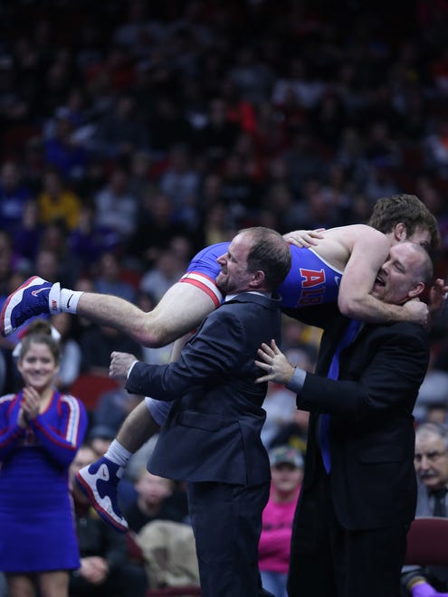 Albia's Aden Reeveshis celebrates with his coaches after winning his match against Sergeant Bluff-Luton's Jack Gaukel during the championship round of the class 2A Iowa high school state wrestling tournament on Saturday, Feb. 17, 2018, in Wells Fargo Arena.
