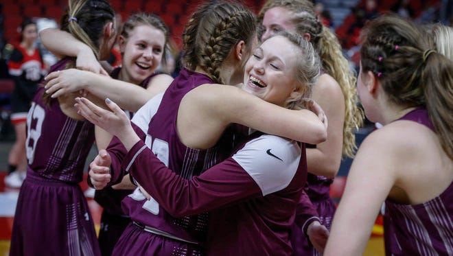 Members of the Grundy Center girls basketball team celebrate a win over Treynor in Class 2A on Friday, March 2, 2018, at Wells Fargo Arena in Des Moines.