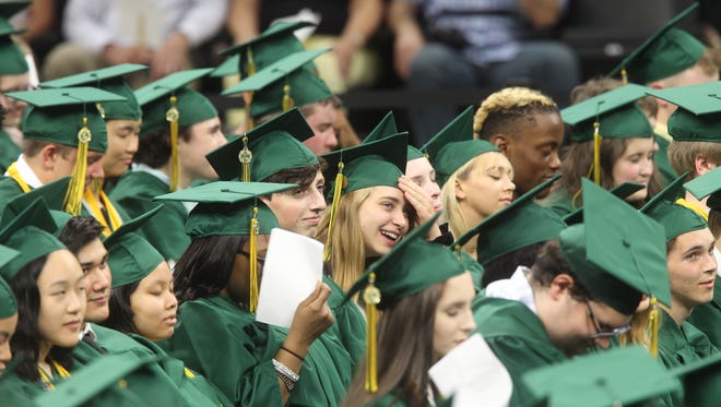 West High Class of 2018 graduating seniors smile during the commencement ceremony on Saturday, May 26, 2018, at Carver-Hawkeye Arena.