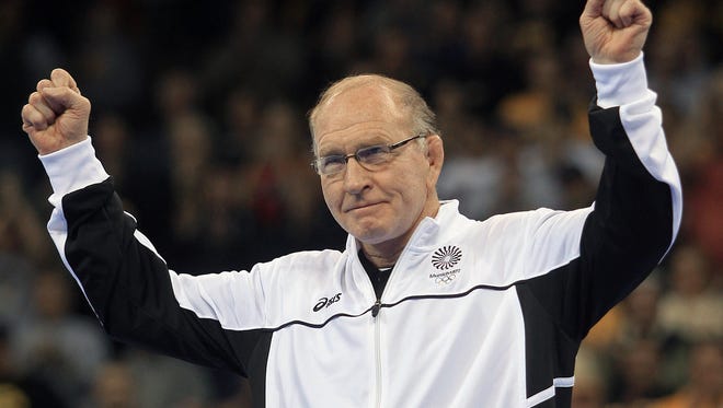 Former Iowa head wrestling coach Dan Gable  acknowledged the cheering crowd as the 1972 olympic wrestling team was introduced during final matches at the U.S. Olympic Wrestling Trials held at Carver-Hawkeye Arena in Iowa City on Saturday night  April 21st, 2012.