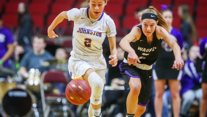 Johnston's(2)Maya McDermott drives past Waukee's(2) Lindsay Kelderman during their first round 5A matchup in the girls' state basketball tournament Monday, Feb. 26, 2018, at Wells Fargo Arena in Des Moines, Iowa.
