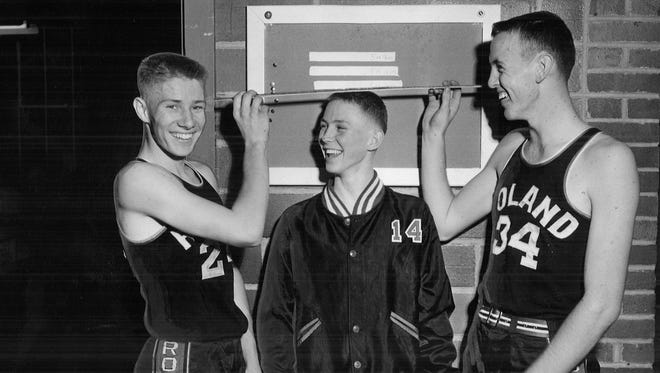 1953: Roland High School basketball players Gary Thompson, left, and Stan Tjernagel, right, measure teammate Marvin Christian.