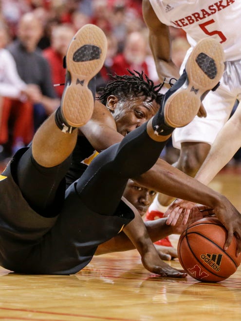 Iowa's Tyler Cook, front, and Nebraska's Jordy Tshimanga, bottom rear, go for the ball during the second half of an NCAA college basketball game in Lincoln, Neb., Saturday, Jan. 27, 2018. (AP Photo/Nati Harnik)