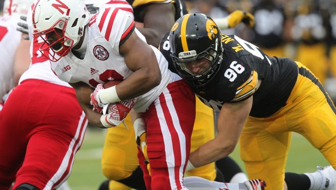 Matt Nelson, wrapping up a Nebraska ballcarrier last fall, is sitting out of spring practices for Iowa with a right foot injury. He is being looked at as somebody who could play both defensive end and defensive tackle.