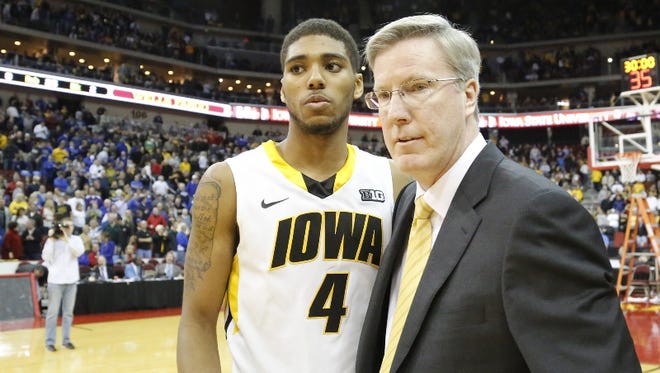 Iowa Hawkeyes head coach Fran McCaffery  hugs Iowa Hawkeyes guard Devyn Marble (4) at mid court after defeating the Northern Iowa Panthers 80-73 in the Big 4 Classic NCAA Mens Basketball tourney at the Wells Fargo Arena in Des Moines.