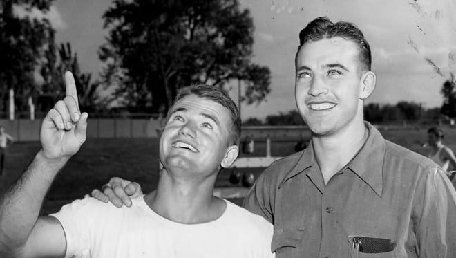 Sept. 18, 1941 - Two former Iowa teammates who will soon be buddies in the sky are pictured. Iowa's famous all-American Nile Kinnick who is coaching under Dr. Eddie Anderson and marking time until he's called to the naval air corps at Pensacola, Fla., in the fall and Jerry Niles, Davenport, one-time back and center on the Hawk teams before Anderson came to Iowa. Niles has been attending Michigan State and will enter the naval air corps soon.