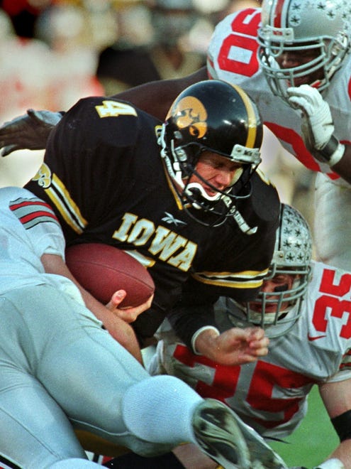 From 1998: Iowa's Kyle McCann, who relieved injured quarterback Scott Mullen, is surrounded by Buckeyes defenders Mike Collins, Clinton Wayne and Jerry Rudzinski.