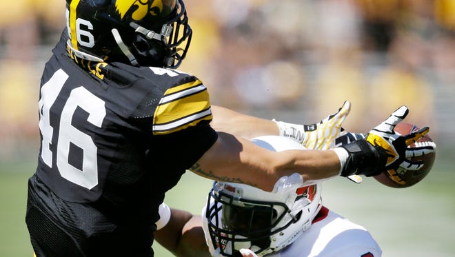 Ball State safety Brian Jones, right, breaks up a pass intended for Iowa tight end George Kittle during the first half of an NCAA college football game, Saturday, Sept. 6, 2014, in Iowa City, Iowa. Jones was called for interference on the play.