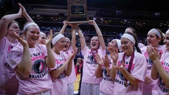 Members of the Crestwood girls basketball team hold the Class 3A state championship trophy after the Cadets beat Sioux Center on Saturday, March 3, 2018, during the Iowa high school girls basketball state championship game at Wells Fargo Arena in Des Moines.
