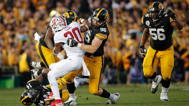 Iowa defensive end Matt Nelson hits Stanford Bryce Love on Friday, Jan. 1, 2016, at the Rose Bowl in Pasadena, Calif.