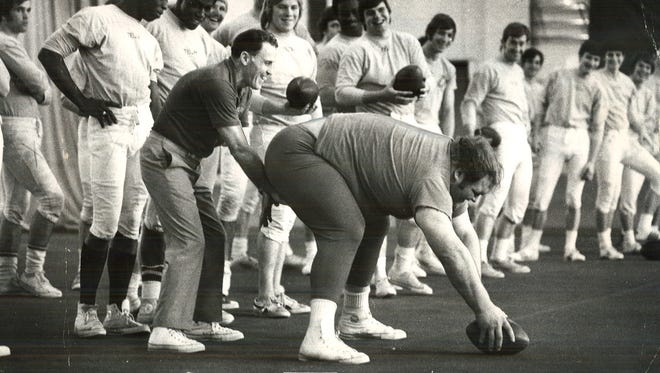 From 1972: Iowa State wrestling champion Chris Taylor snaps a football to assistant coach Arch Steele.