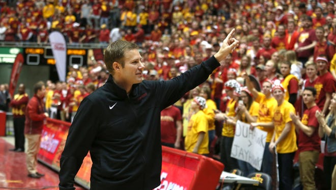 Coach Fred Hoiberg waves to fans as he leaves the court following an interview with ESPN on Jan. 17, 2015, at Hilton Coliseum in Ames.