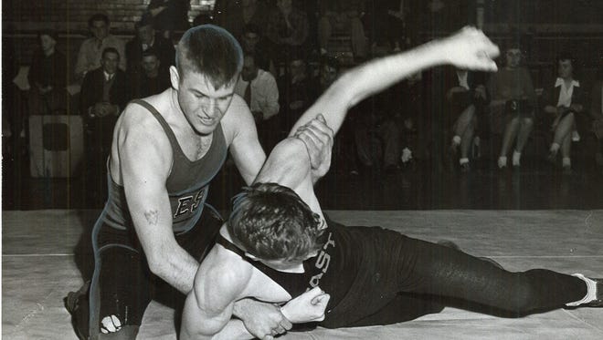 1946: Lowell Lange, West Waterloo High's 145-pound state wrestling titleholder, starts Dick Sherwood's shoulders to the canvas in the semifinal round of the Big Seven loop's mat tournament. The East Waterloo grappler was Lange's forty-first victim.