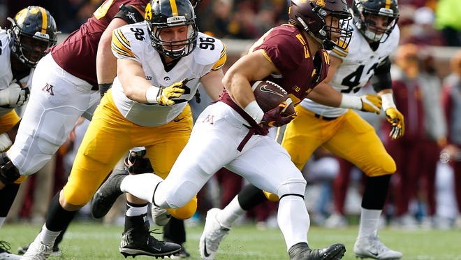 Minnesota running back Shannon Brooks (23) runs out of reach of Iowa defensive end Matt Nelson (96) during an NCAA college football game Saturday, Oct. 8, 2016, in Minneapolis. (AP Photo/Stacy Bengs)
