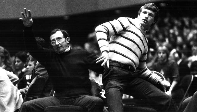 1986: Dowling Catholic wrestling coach Bob Darrah, left, and assistant Ron Gray are animated during a match during the state wrestling tournament.