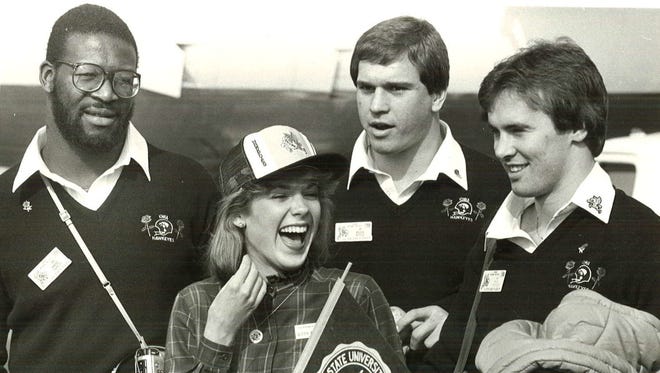 Iowa captains Andre Tippett, Bruce Kittle and Tracy Crocker talk to Rose Bowl Queen Katy Potthast during their 1986 Rose Bowl trip.