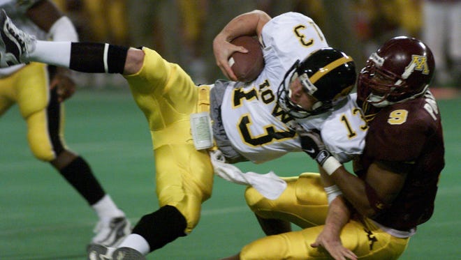 From 1998: Iowa quarterback Randy Reiners is sacked by Minnesota defender Curtese Poole.