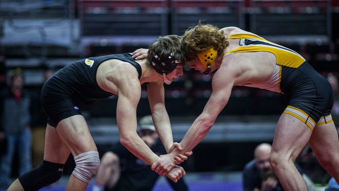 Southeast Polk's Nathan Marchand wrestles Johnston's Sterling Brunk during the Iowa high school state dual team wrestling quarterfinal on Wednesday, Feb. 14, 2018, in Wells Fargo Arena.
