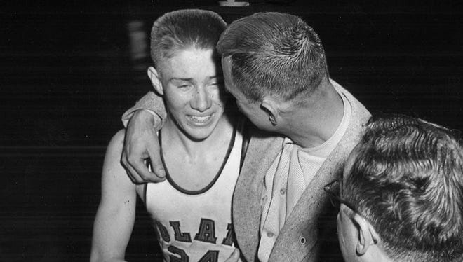 Buck Cheadle, right, and Roland basketball star Gary Thompson share a hug during the 1953 state basketball tournament. Cheadle coached Roland to the state championship game in 1951 and 1952 before leaving to coach at Burlington.
