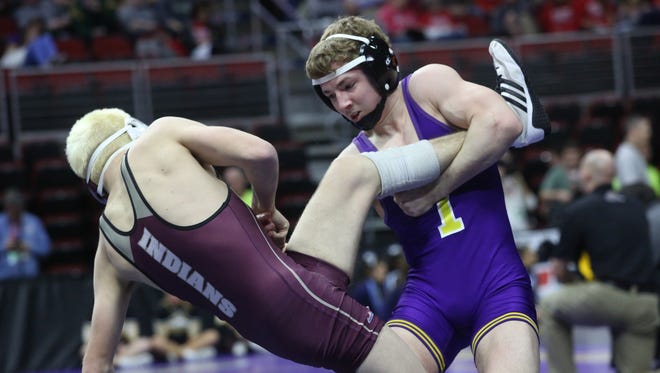 Indianola senior 120-pounder Connor Sexton (in purple) wrestles Oskaloosa senior Josh Diehl in a Class 3A consolation match at the state wrestling meet Feb. 16 at Wells Fargo Arena in Des Moines.