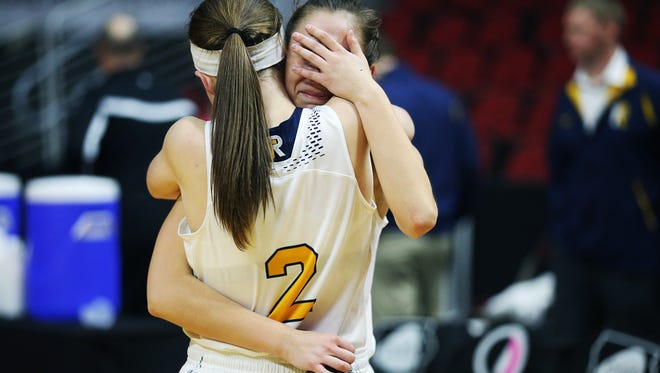 Iowa City Regina's Mary Crompton and Greyson Dumont hug each other after losing the Class 2A Girls' state basketball quarterfinal game between Iowa City Regina and Grundy Center on Tuesday, Feb. 27, 2018, in Wells Fargo Arena. Grundy Center won the game, 46-45.