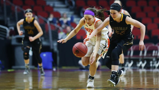 Springville's Rylee Menster and Garrigan's Jenna Boelter run after a loose ball during the Class 1A Girls' state basketball quarterfinal game between Springville and Algona Bishop Garrigan on Wednesday, Feb. 28, 2018, in Wells Fargo Arena.