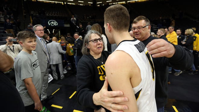 Patty and Mike Street, parents of Chris Street, share a moment with Jordan Bohannon, who kept Chris Street's consecutive free throw record intact, following the Hawkeyes' game against Northwestern at Carver-Hawkeye Arena on Sunday, Feb. 25, 2018.