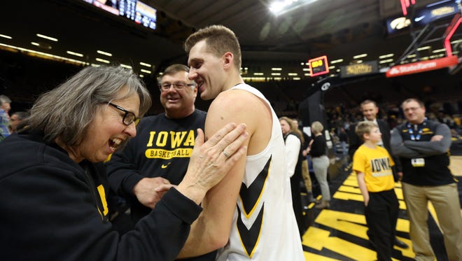 Patty and Mike Street, parents of Chris Street, share a moment with Jordan Bohannon, who kept Chris Street's consecutive free throw record intact, following the Hawkeyes' game against Northwestern at Carver-Hawkeye Arena on Sunday, Feb. 25, 2018.