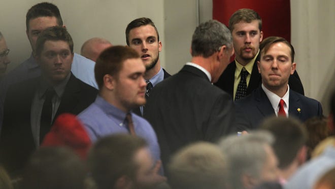 Iowa football players find spots to stand after meeting Republican presidential candidate Donald Trump at the University of Iowa Field House in Iowa City on Tuesday, Jan. 26, 2016.