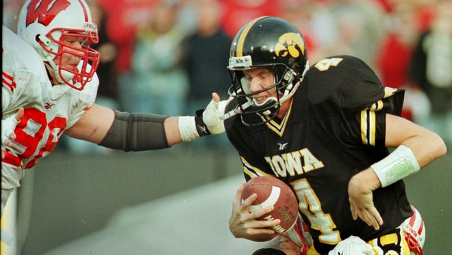 From 1998: Iowa quarterback Kyle McCann is sacked by Wisconsin's Eric Mahlik, left, and Tom Burke.