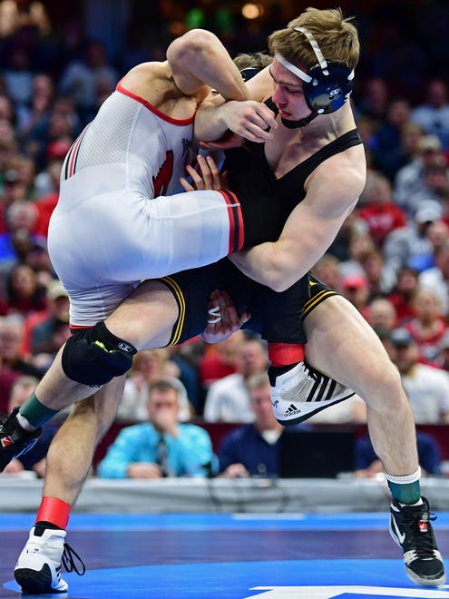 Iowa's Spencer Lee, right, controls Rutgers' Nick Suriano during the 125-pound championship match of the NCAA Division I Wrestling Championships, Saturday, March 17, 2018, in Cleveland. Lee would win the match.