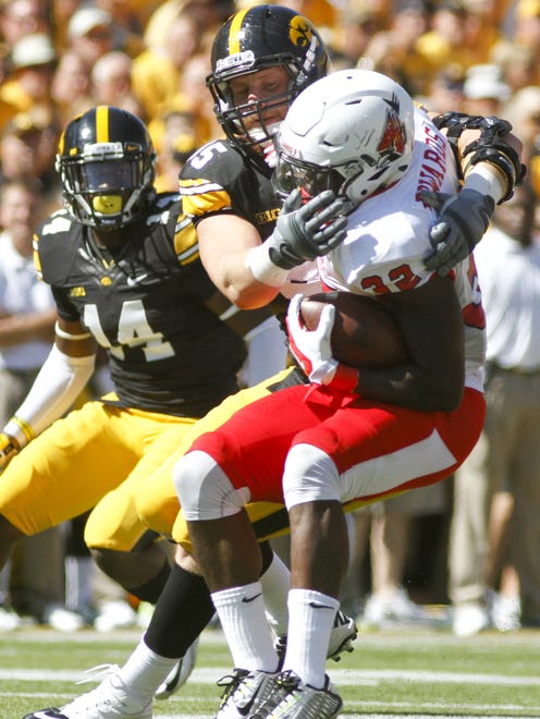 Defensive lineman Drew Ott (95) of the Iowa Hawkeyes tackles running back Jahwan Edwards (32) of the Ball State Cardinals during the first quarter on Sept. 6, 2014 at Kinnick Stadium in Iowa City, Iowa.