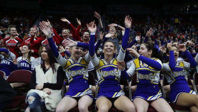 Cheerleads dance to warm up music during the championship round of the class 2A Iowa high school state wrestling tournament on Saturday, Feb. 17, 2018, in Wells Fargo Arena.