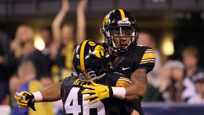Iowa's Tevaun Smith celebrates his 85-yard touchdown with George Kittle during the Hawkeyes' Big Ten Championship game against Michigan State at Lucas Oil Stadium in Indianapolis, Ind. on Saturday, Dec. 5, 2015.