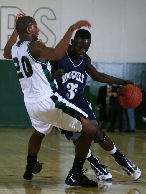 Roosevelt's Peter Jok tries to get around North's Corey McMillian in the first half of their game at North on Dec. 18, 2009.