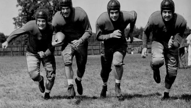 Nile Kinnick, second from the left, at a college all-stars practice before a game at Soldier's Field in Chicago against pro players from the Green Bay Packers. In this picture from left are Joe Thesing (Notre Dame), Kinnick, Lou Brock (Purdue) and Ambrose Schindler (USC).